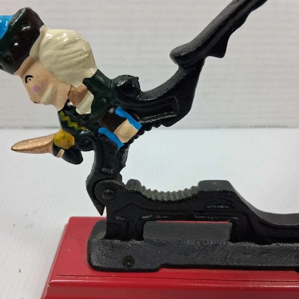 Vintage Cast Iron Mechanical Nutcracker Soldier Figure on Red Wood‎ Base Black